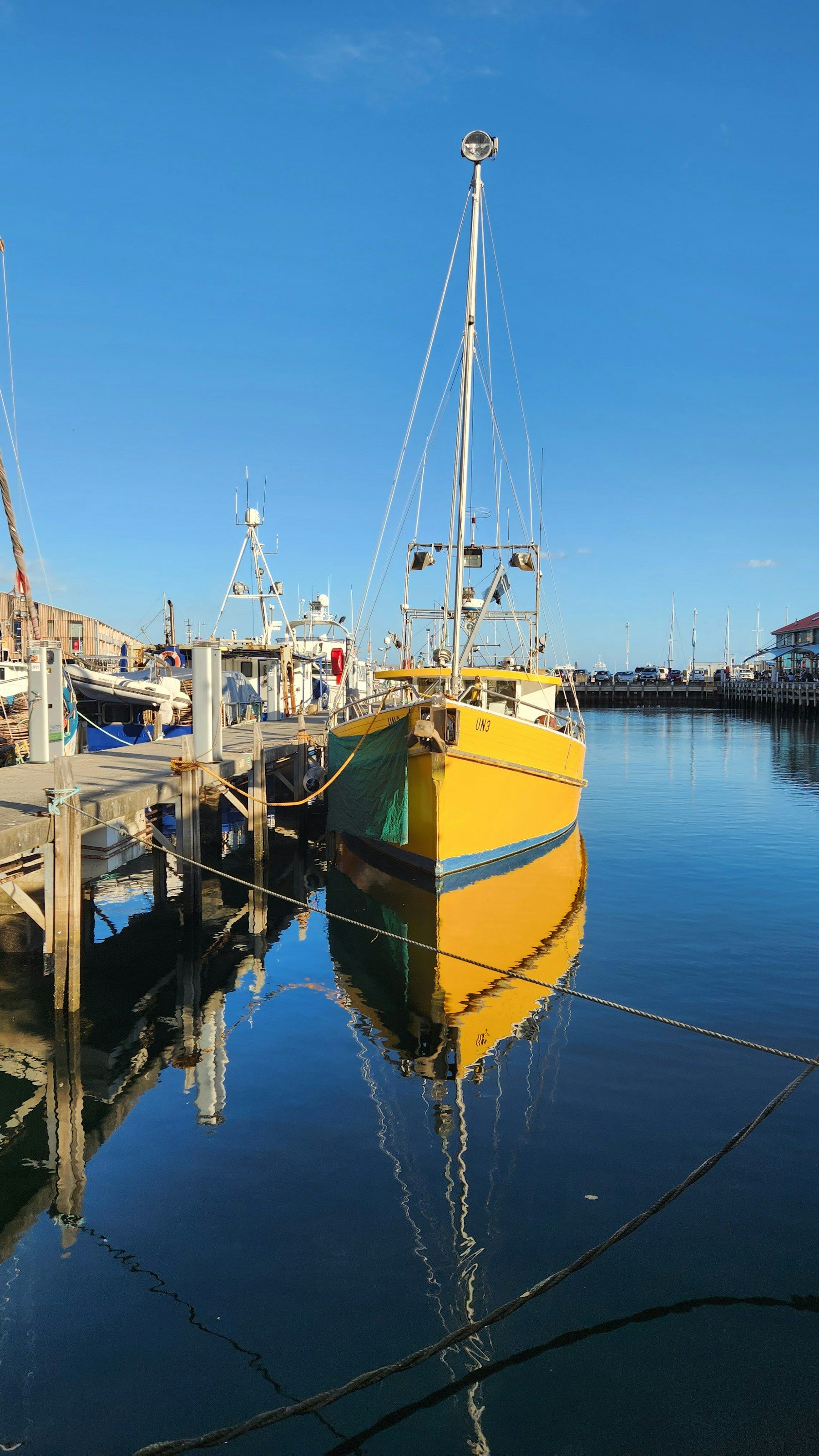 Yellow fishing boat moored at a harbour